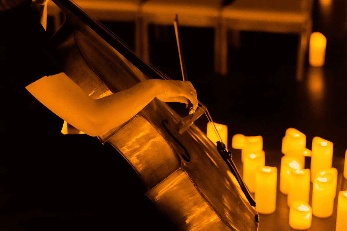 Musician plays cello by candlelight