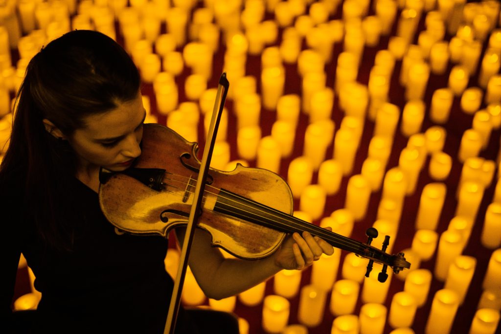 close up of violinist performing at a Candleigiht concert