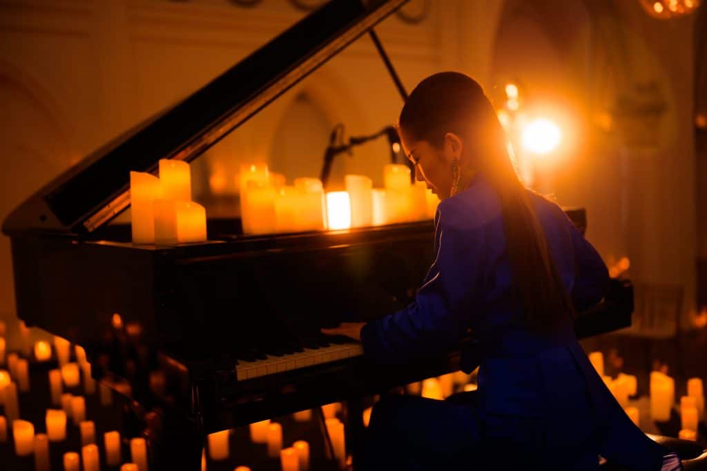 pianist performing surrounded by candles