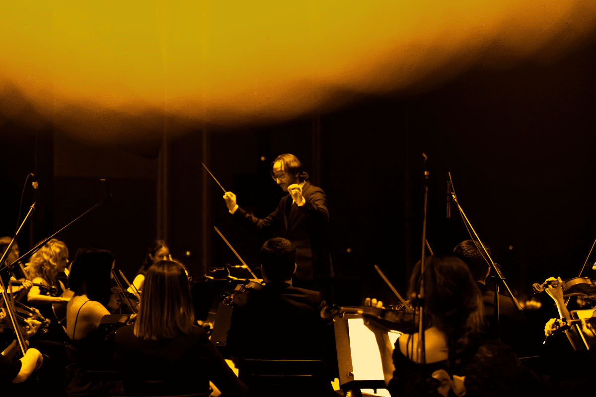 A conductor leading the Candlelight orchestra 